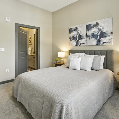 a bedroom with a bed and two nightstands