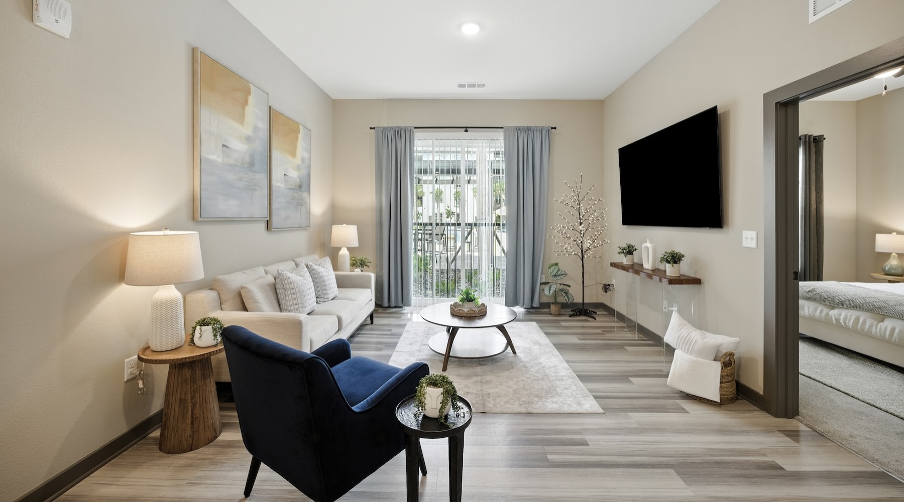 a living room with a tv, couch, table and chair