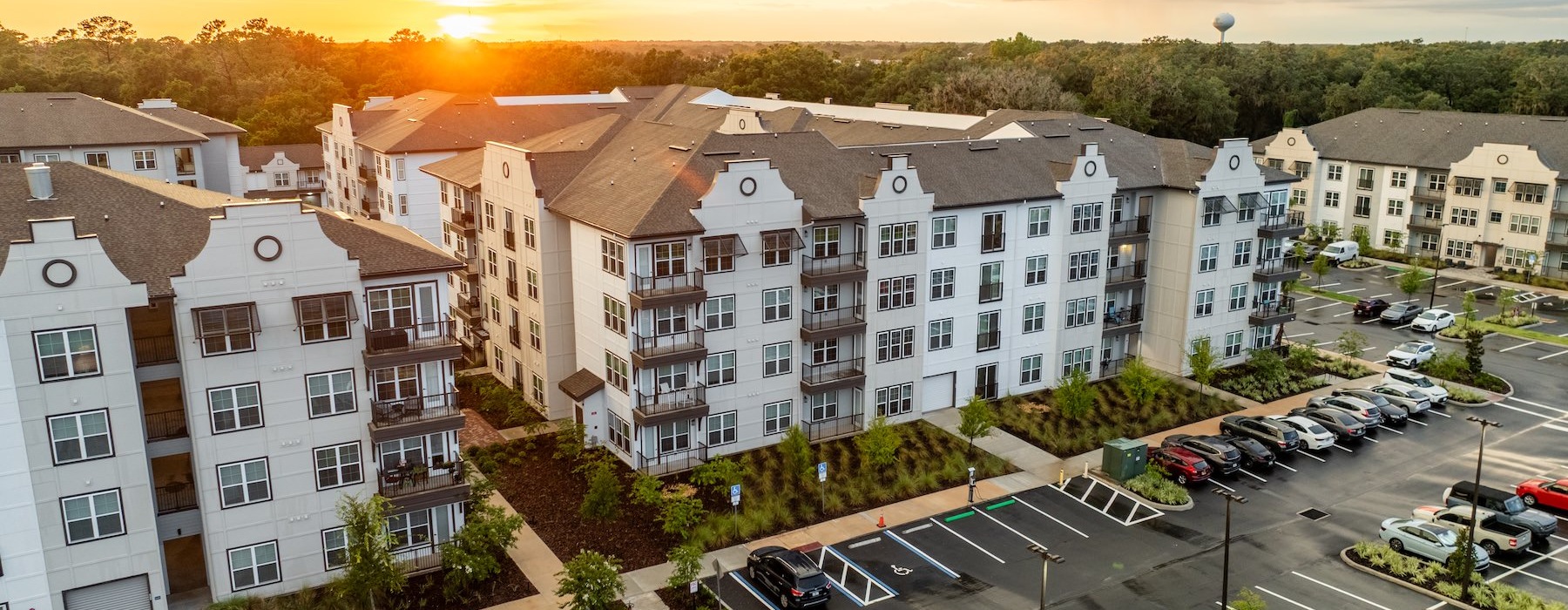 an aerial view of an apartment complex with cars