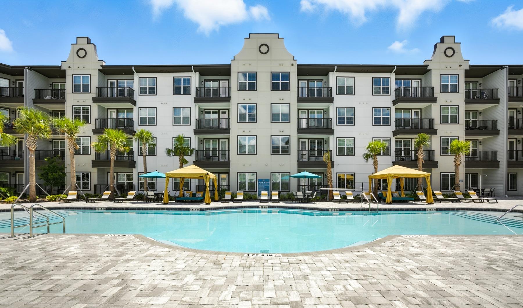 a large building with a pool in front of it